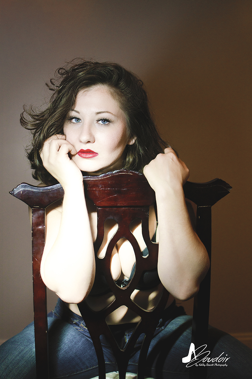 light and matte portrait of woman in backwards queen anne chair