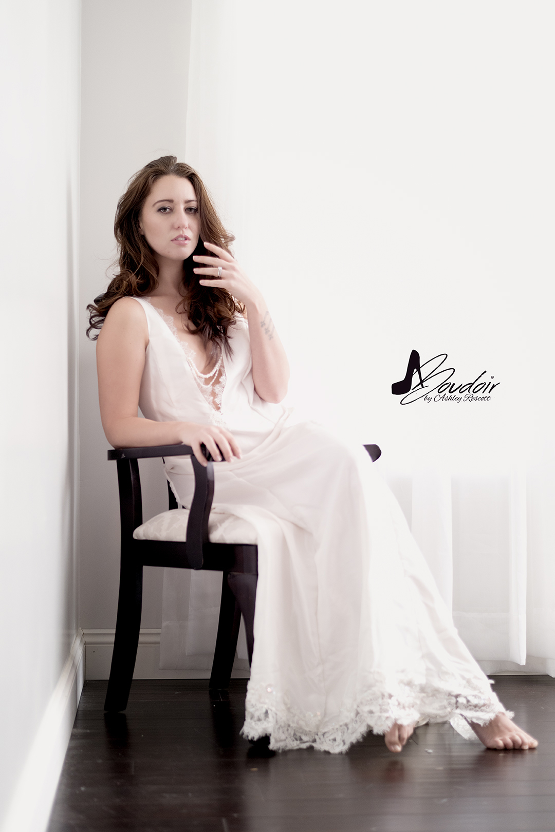 woman sitting in white bridal dressing gown