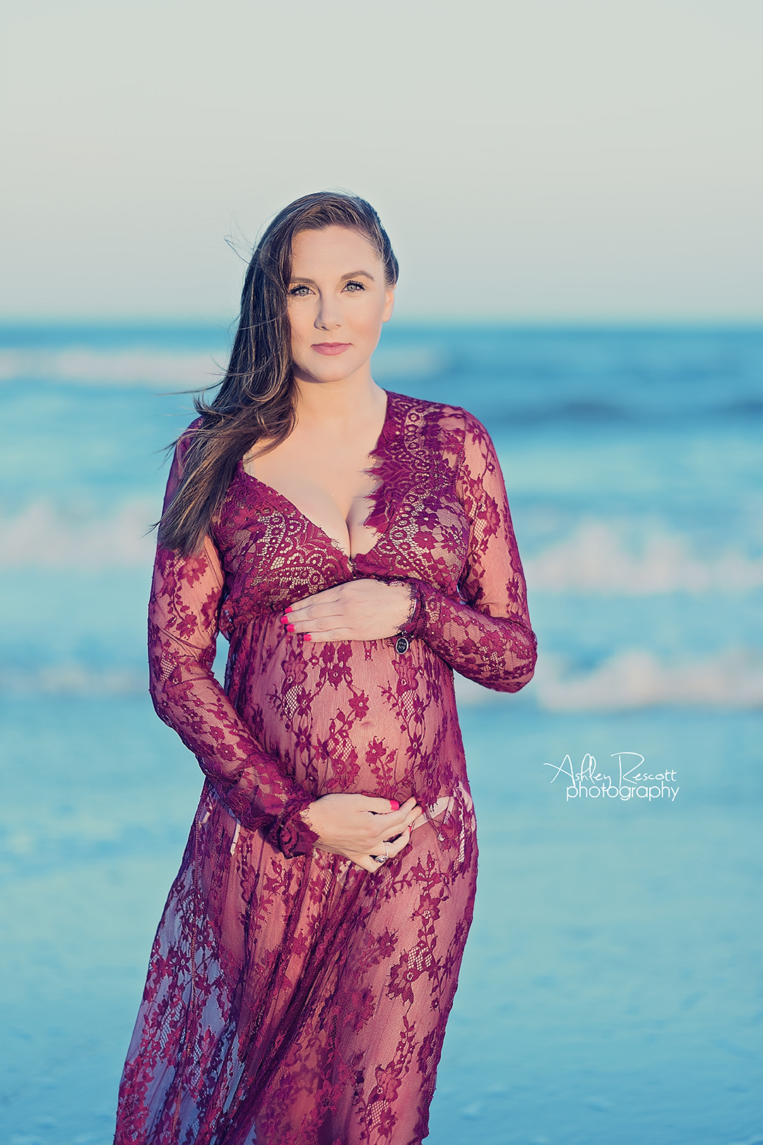 Maternity photo on beach in red lace dress