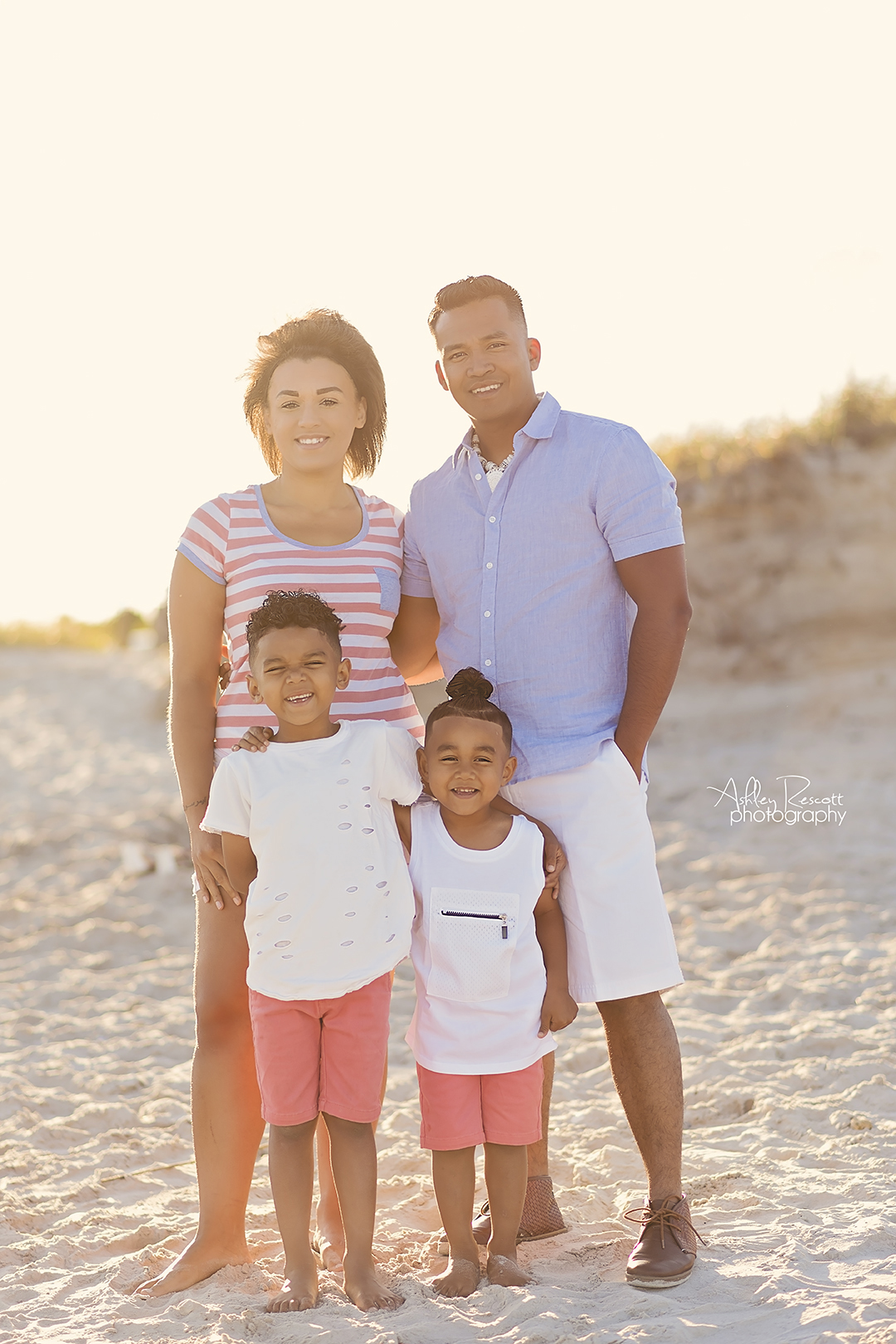 family standing on beach