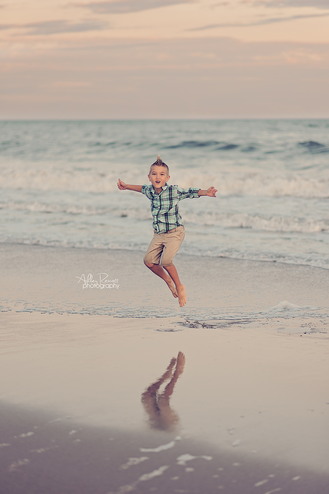 boy jumping in water on beach