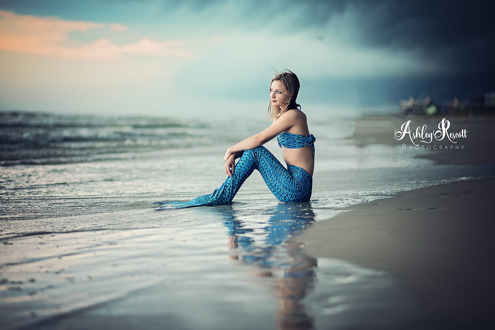 mermaid on beach with stormy skies