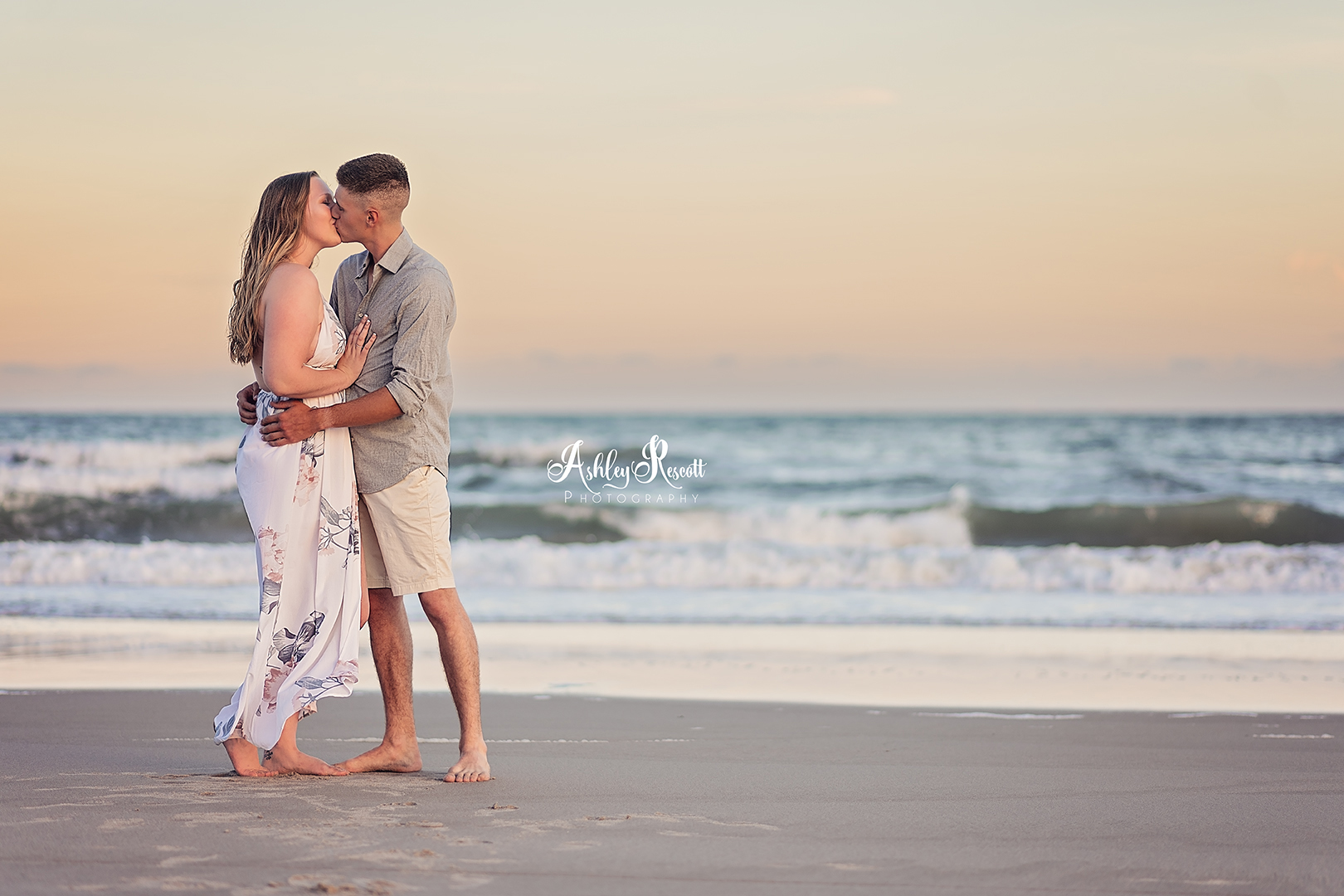 Young couple on beach at sunset