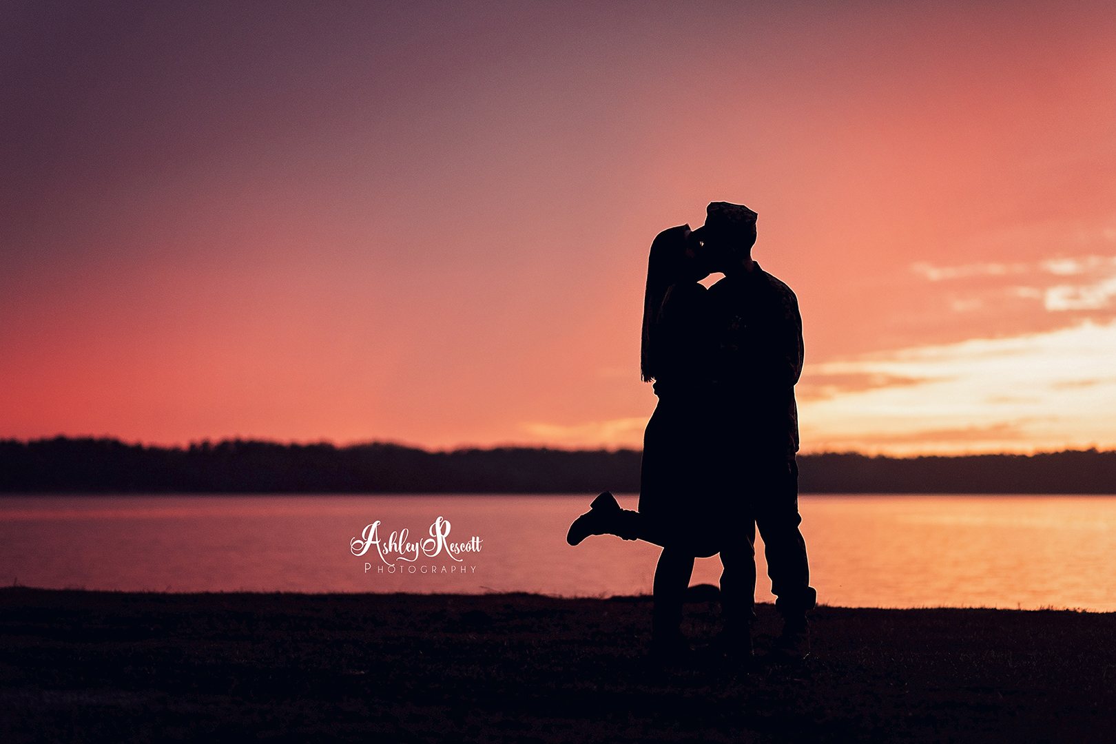 silhouette of couple at sunset near water