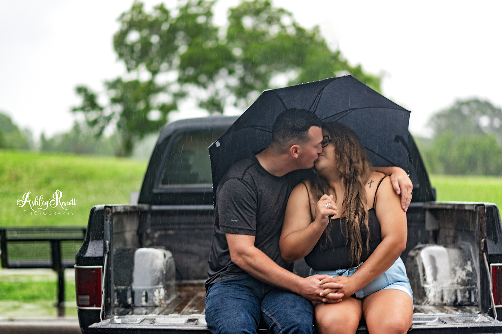 couple sitting in truck bed