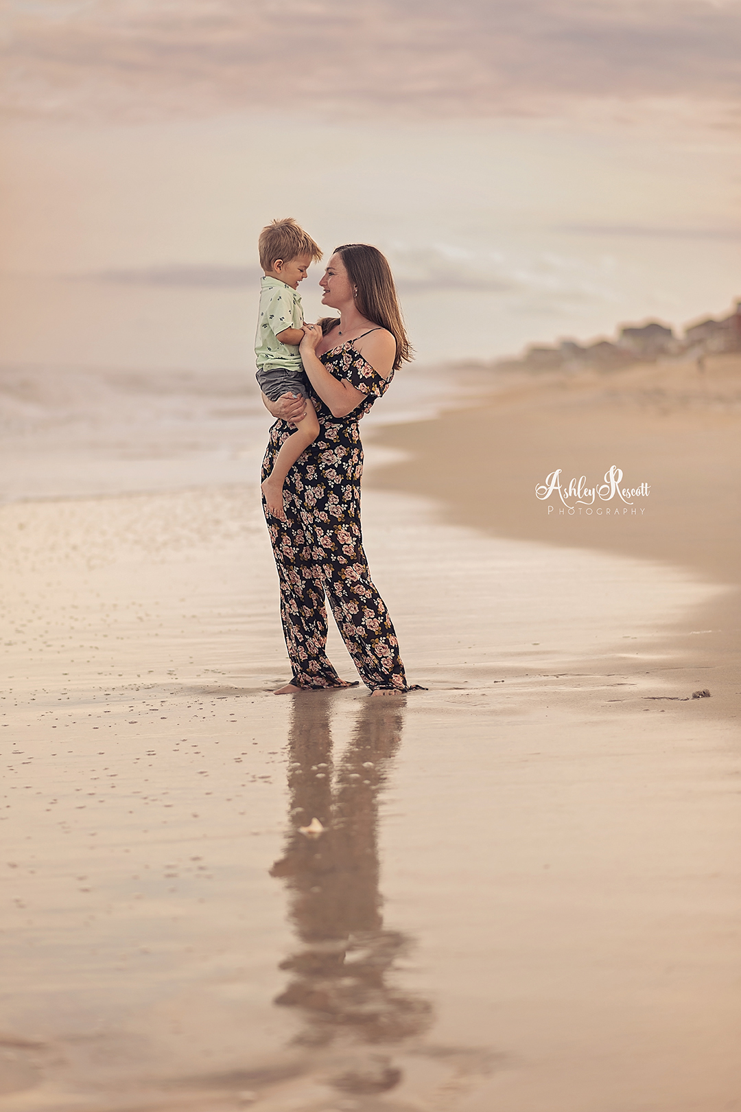mother holding son on beach