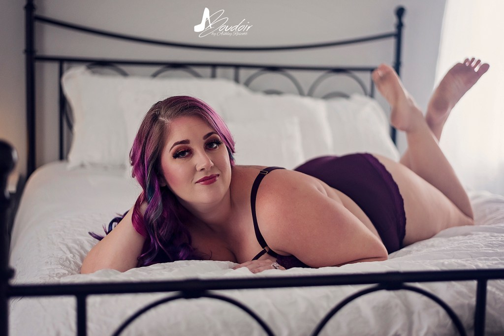 woman lying in bed in purple underwear set