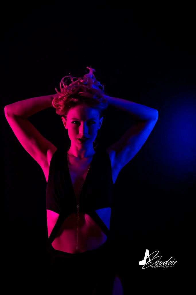 Model in split blue & pink lighting during neon boudoir
