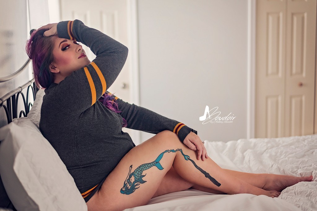 woman sitting in bed in a gryffindor sweater