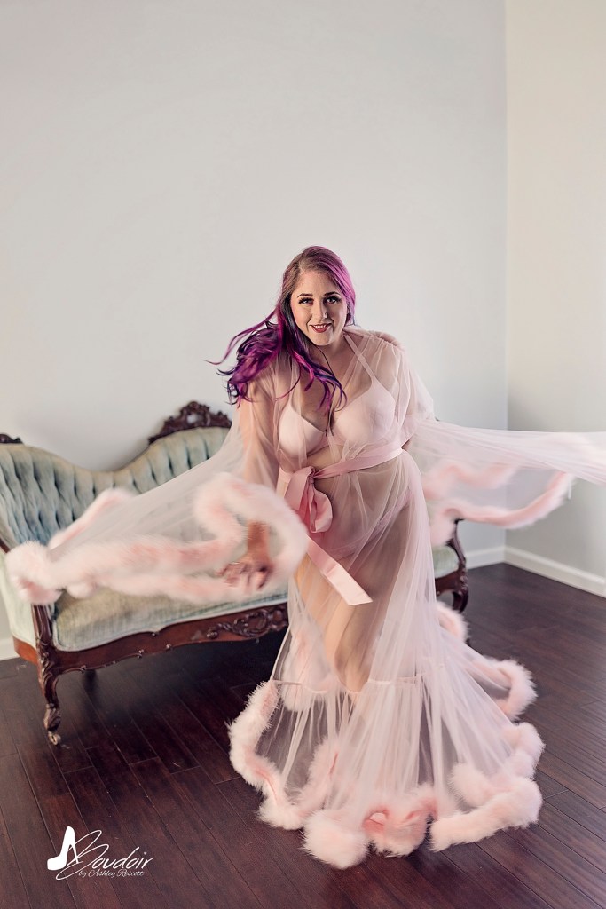 woman with purple hair twirling in robe