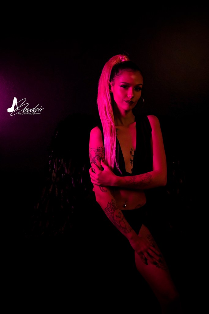 woman in pink neon lighting, dramatic boudoir