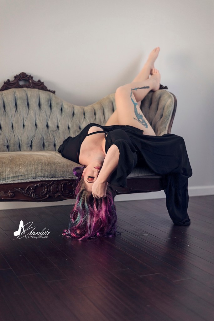 model upside down on couch, arm covering half her face